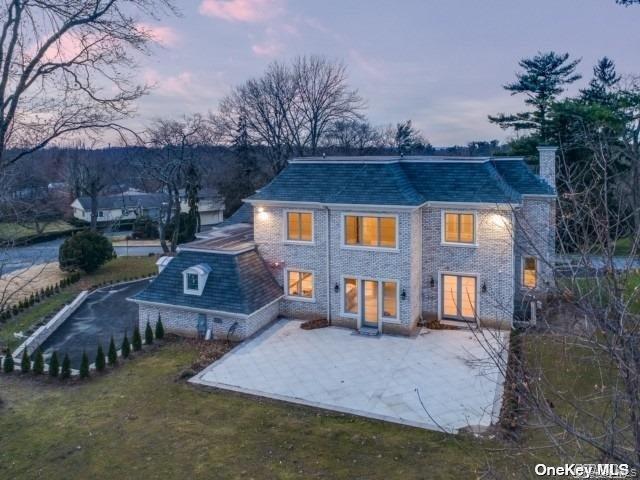 19 Gilbert Road Great Neck, NY 11024 - Photo 32 of 36 a front view of a house with garden