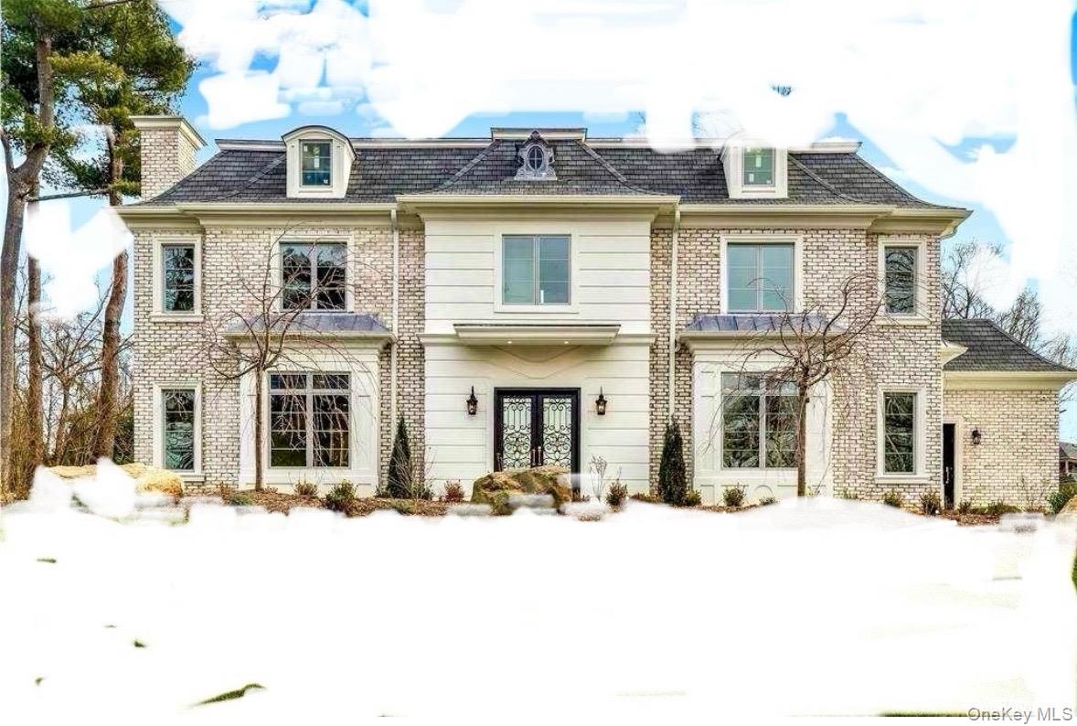 19 Gilbert Road Great Neck, NY 11024 - Photo 36 of 36 a front view of a residential apartment building with a yard