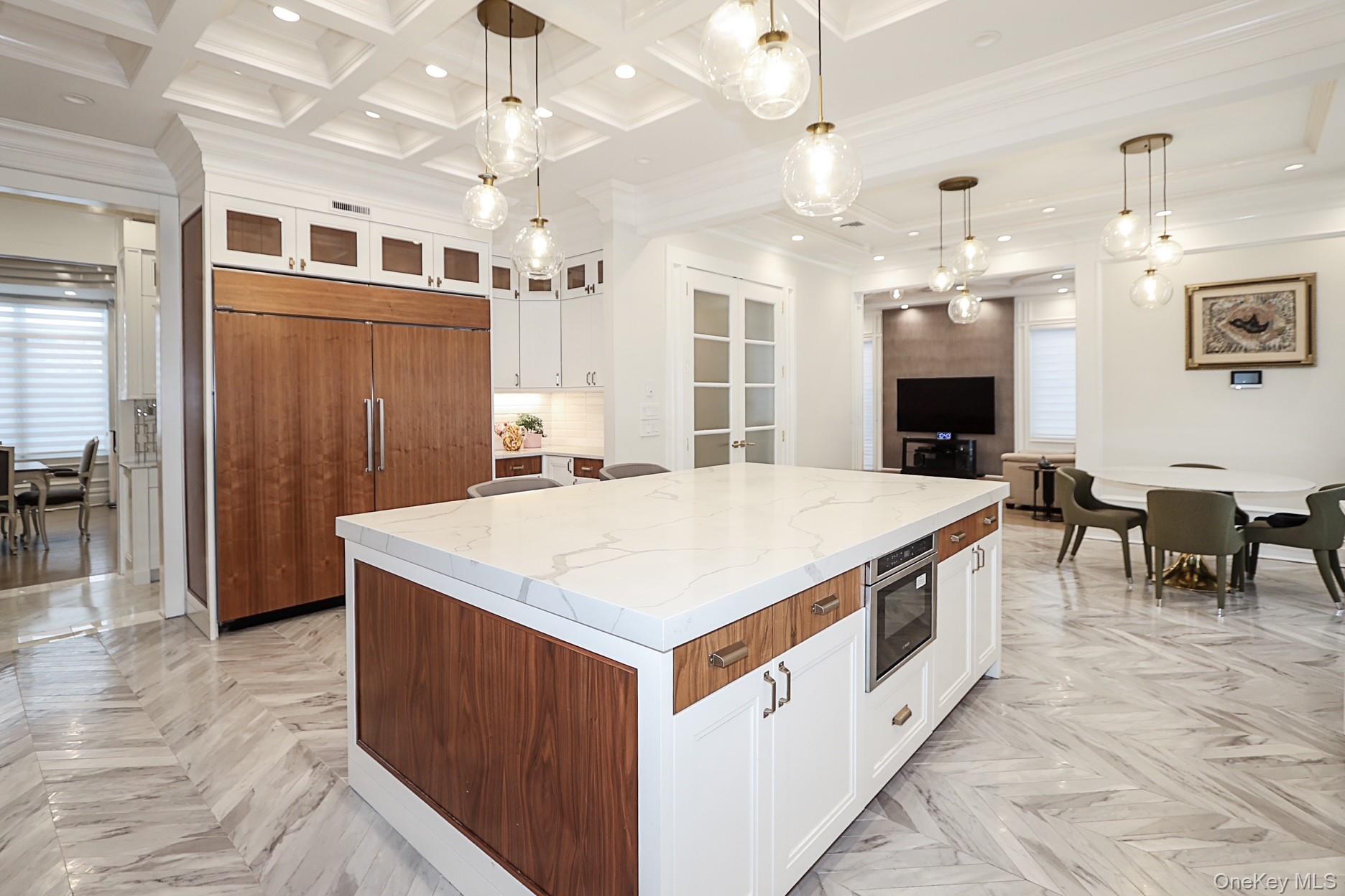 19 Gilbert Road Great Neck, NY 11024 - Photo 10 of 36 an open kitchen with a sink and breakfast area