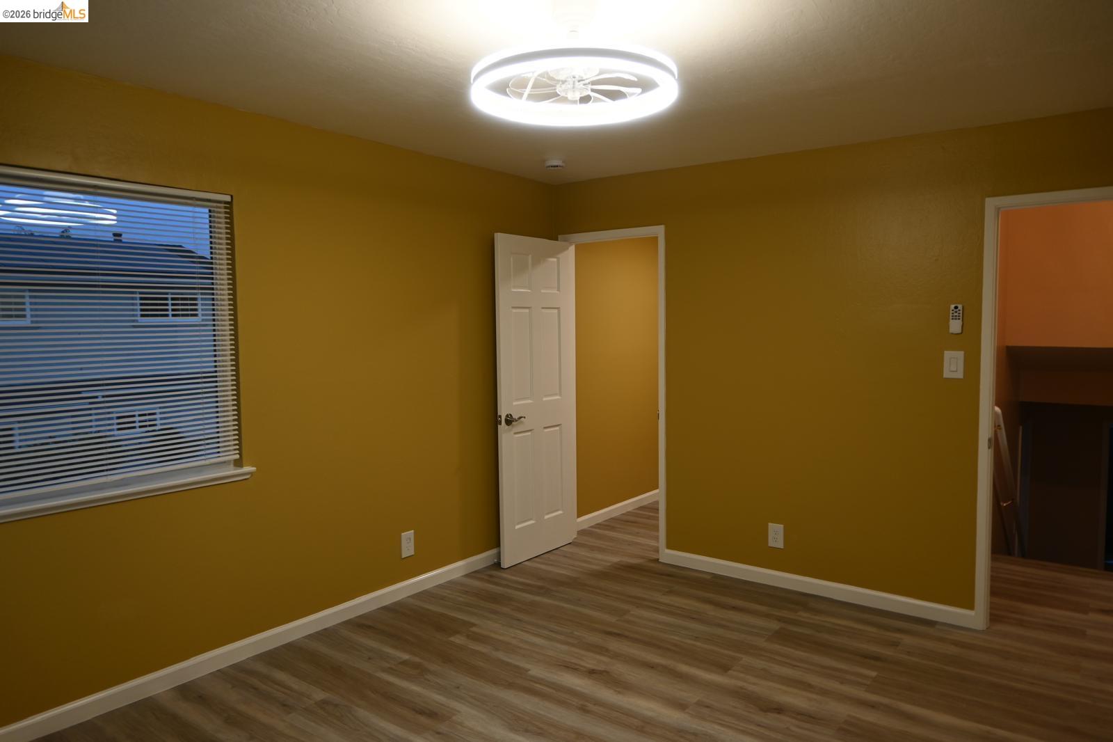 1316 Russell Street Berkeley, CA 94702 - Photo 17 of 23 an empty room with wooden floor and a window