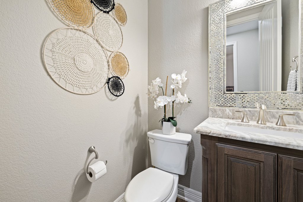 108 Berry Cove Georgetown, TX 78628 - Photo 24 of 39 a bathroom with a sink mirror vanity and toilet
