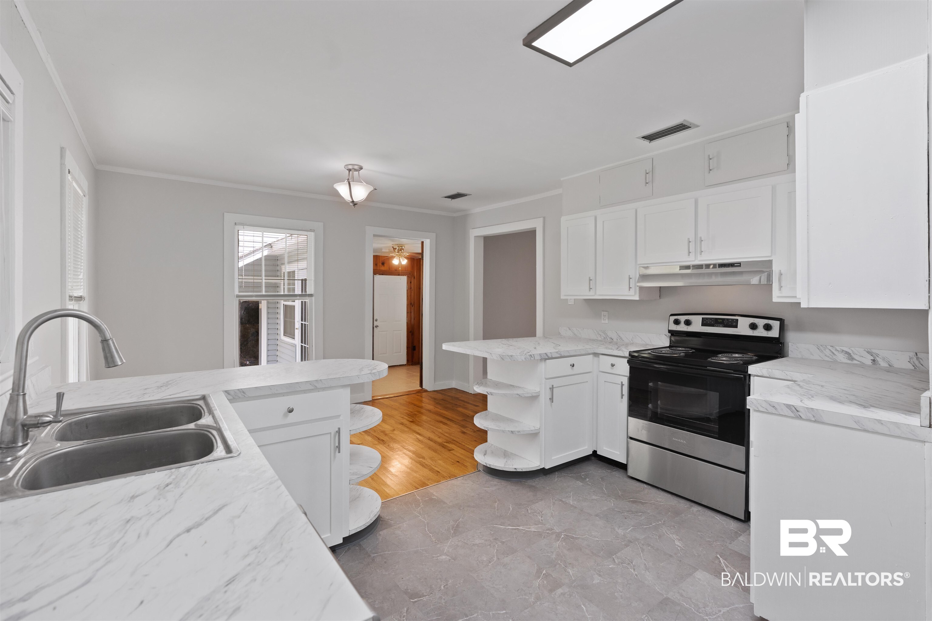 2126 Barron Place Mobile, AL 36605 - Photo 14 of 33 Kitchen with sink, light hardwood / wood-style flooring, electric stove, and ornamental molding