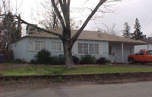1108 4th Street Redding, CA 96002 - Photo 1 of 1 a front view of a house with a yard and garage