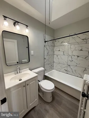 a bathroom with a sink a toilet and bathtub