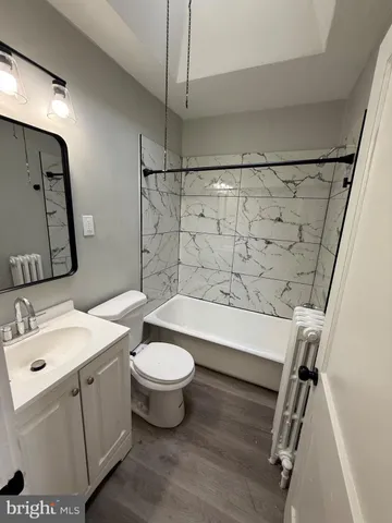 a bathroom with a sink toilet a mirror and shower