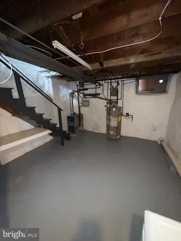 a view of water heater room with stairs