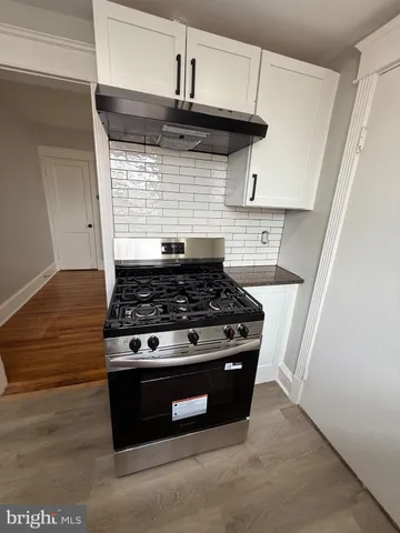 a stove top oven sitting inside of a kitchen