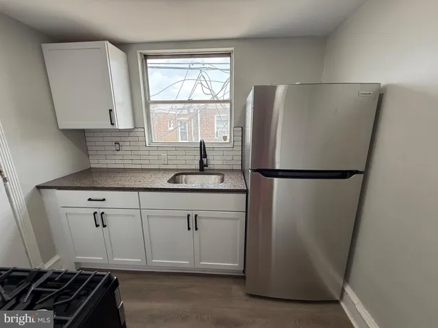 a kitchen with a refrigerator and a sink