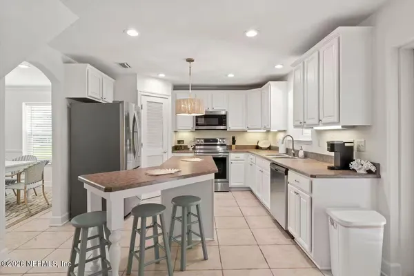 a kitchen with stainless steel appliances granite countertop a refrigerator stove microwave and sink