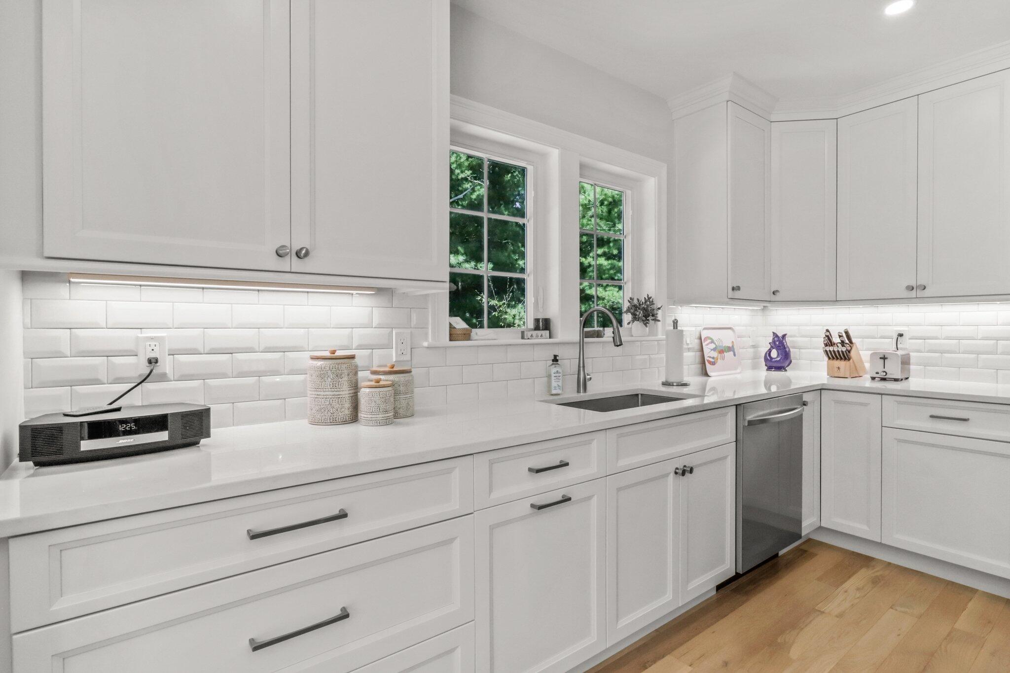 58 Cobblestone Circle Mashpee, MA 02649 - Photo 11 of 49 a kitchen with granite countertop white cabinets and white appliances