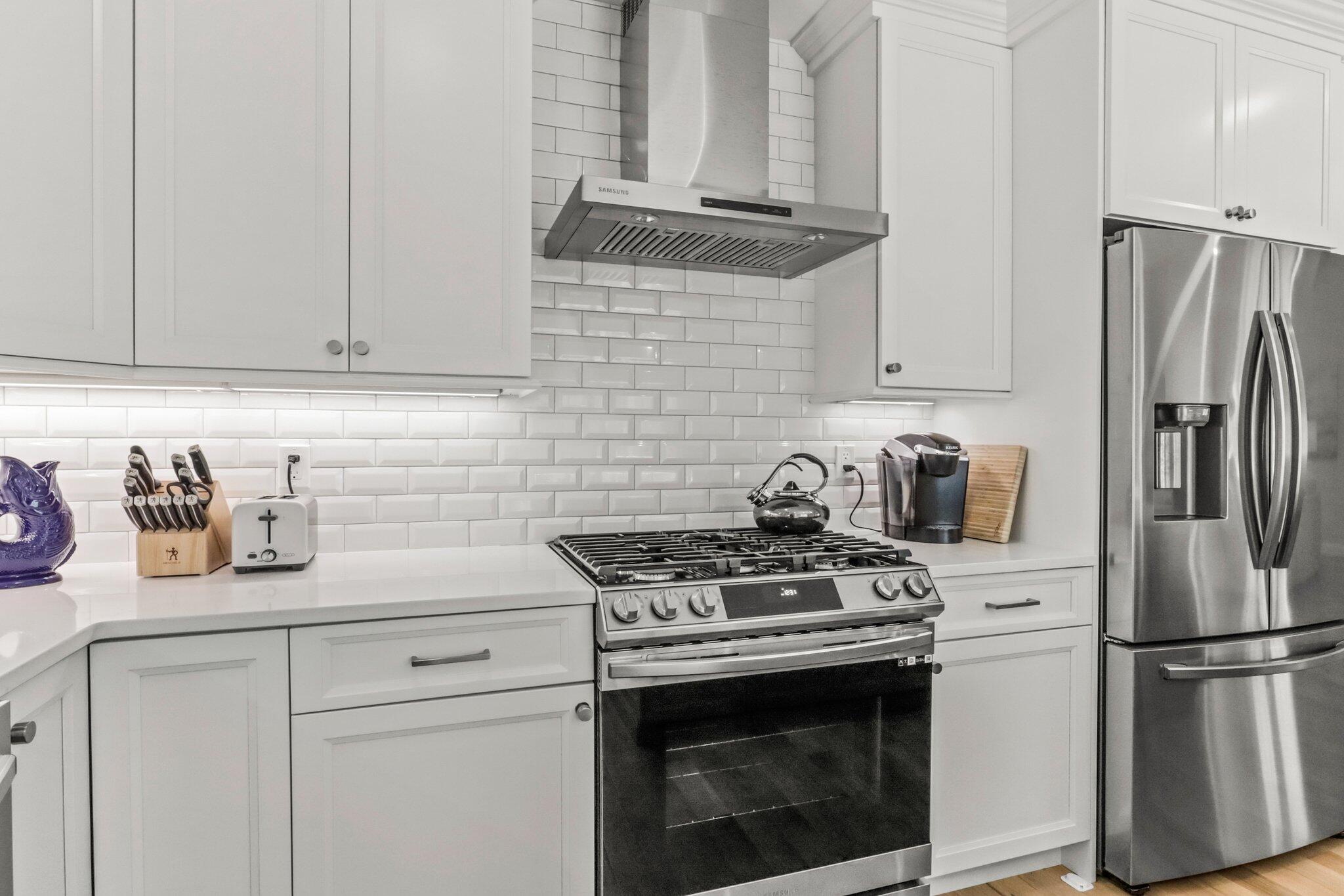 58 Cobblestone Circle Mashpee, MA 02649 - Photo 13 of 49 a kitchen with stainless steel appliances granite countertop a stove a refrigerator and a white cabinets