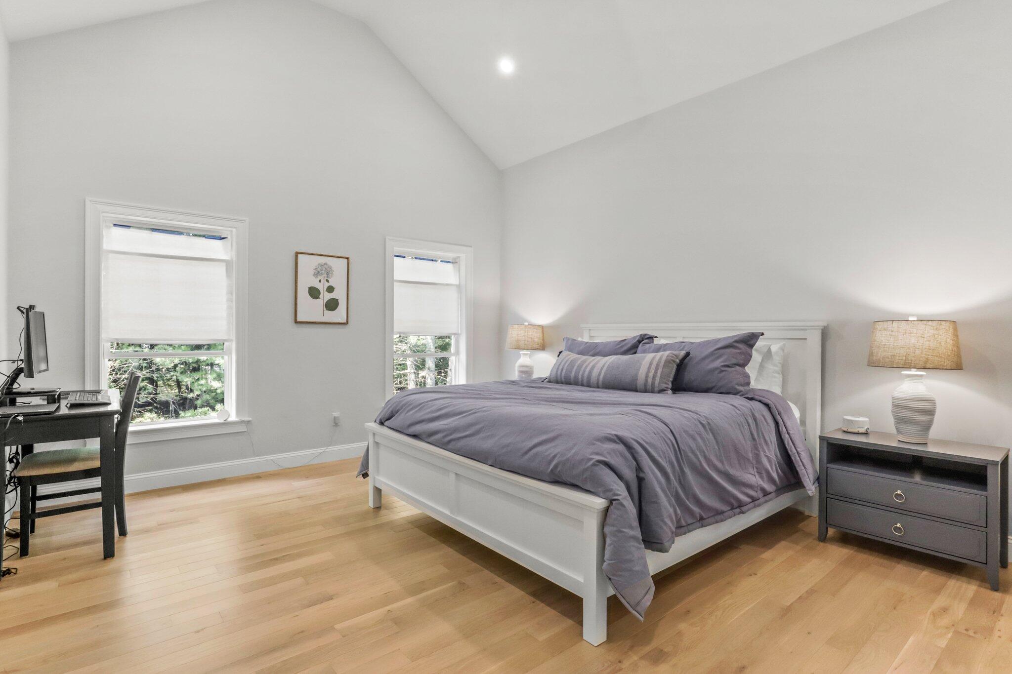 58 Cobblestone Circle Mashpee, MA 02649 - Photo 15 of 49 a spacious bedroom with a bed and a table in it