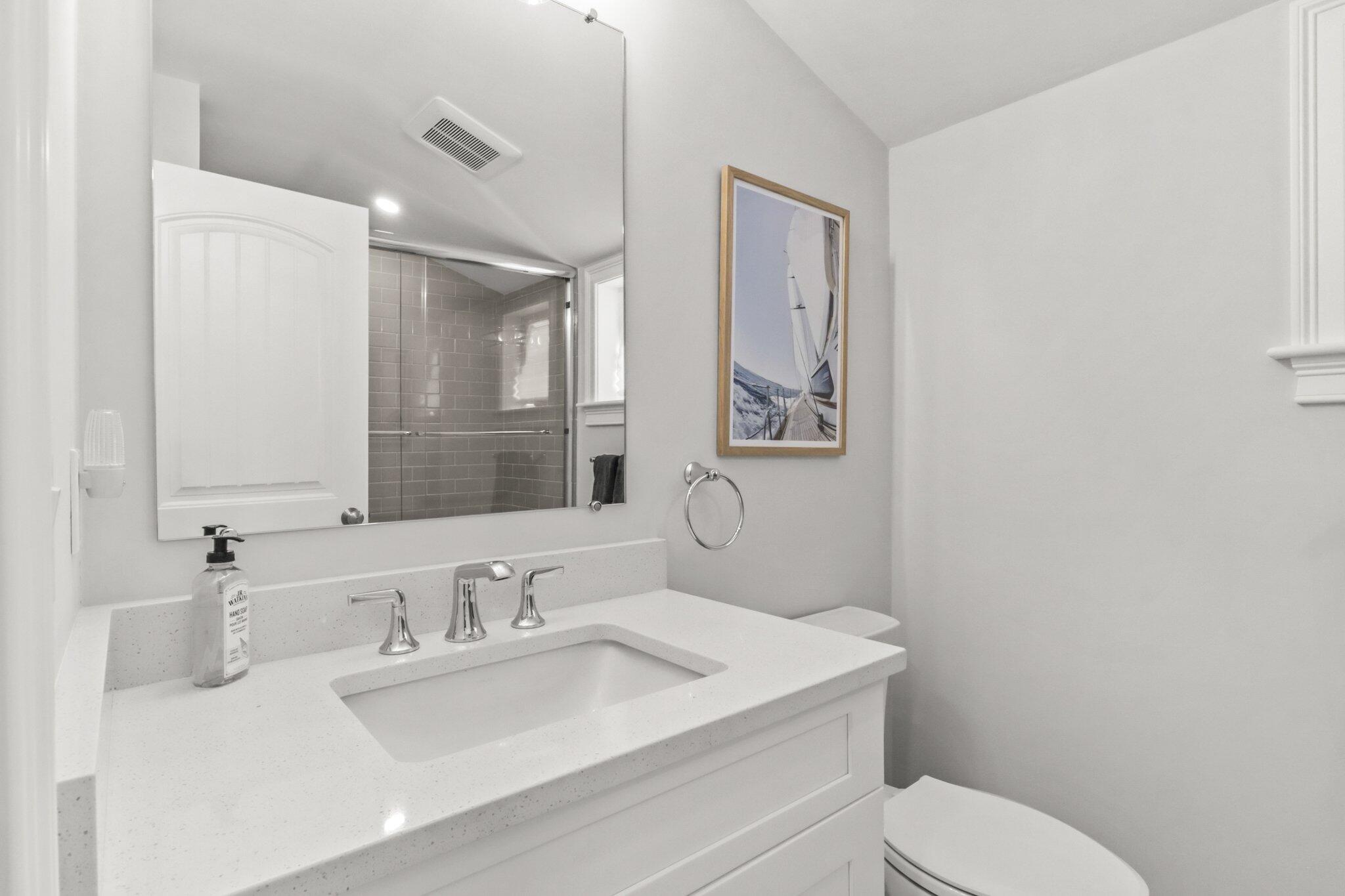 58 Cobblestone Circle Mashpee, MA 02649 - Photo 24 of 49 a bathroom with a toilet sink vanity and mirror