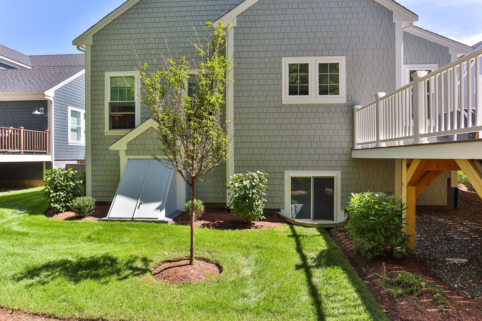 58 Cobblestone Circle Mashpee, MA 02649 - Photo 30 of 49 a view of a house with backyard and a garden