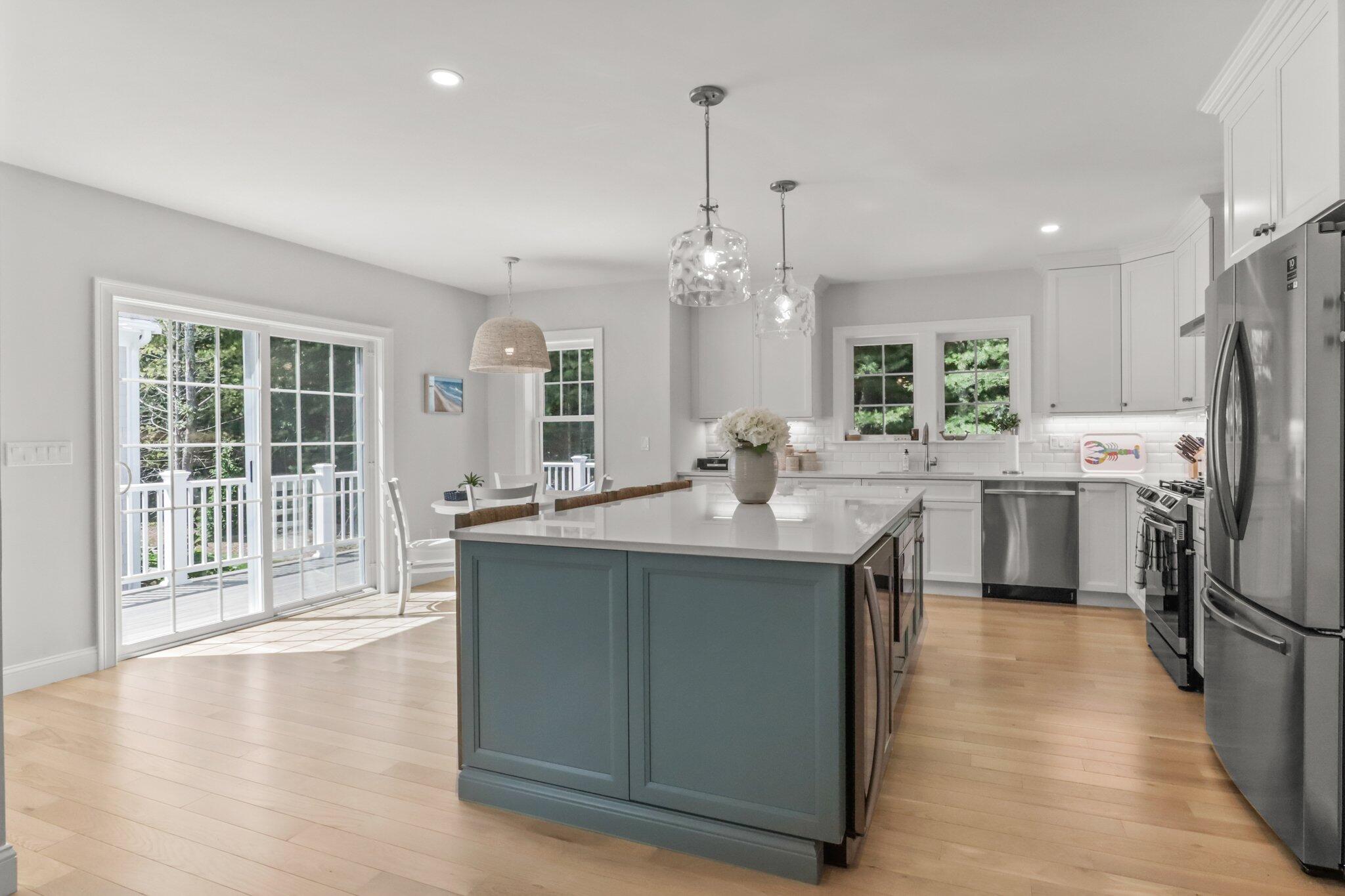 58 Cobblestone Circle Mashpee, MA 02649 - Photo 9 of 49 a kitchen with stainless steel appliances granite countertop a sink a stove and a refrigerator