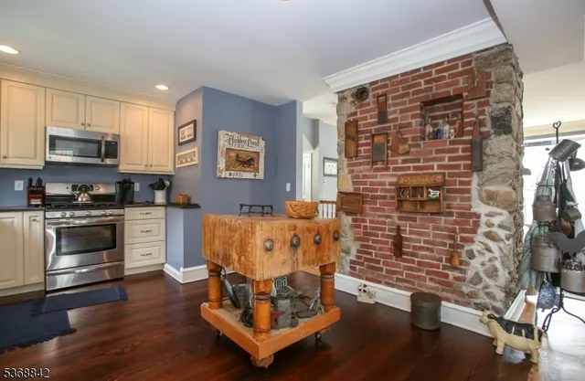 a kitchen with stainless steel appliances white cabinets and a refrigerator