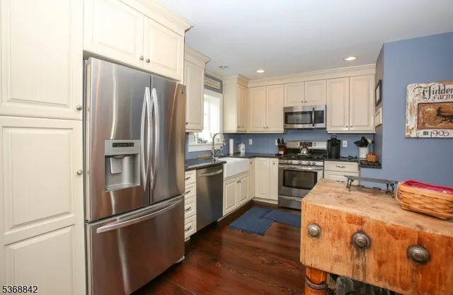 a kitchen with stainless steel appliances white cabinets and a sink