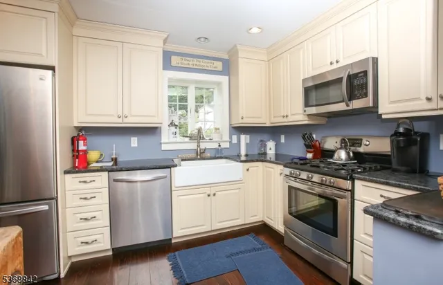a kitchen with stainless steel appliances granite countertop a stove and a refrigerator
