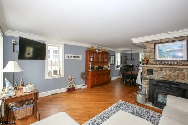 a living room with furniture a flat screen tv and kitchen view