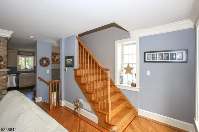 a view of a livingroom with furniture and stairs