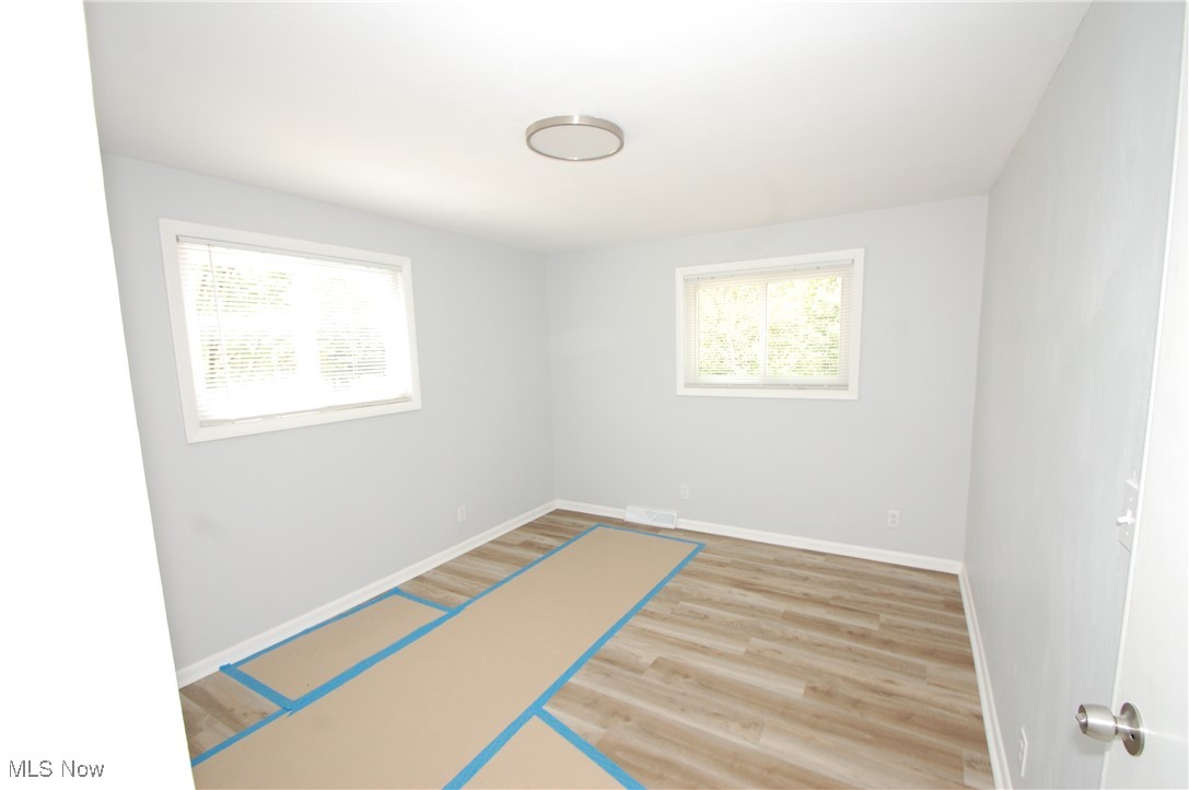 6284 Herbert Road Canfield, OH 44406 - Photo 19 of 24 Spare room featuring baseboards, visible vents, and wood finished floors