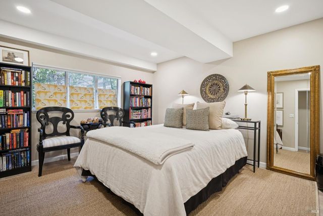 a bedroom with a bed and a bookshelf