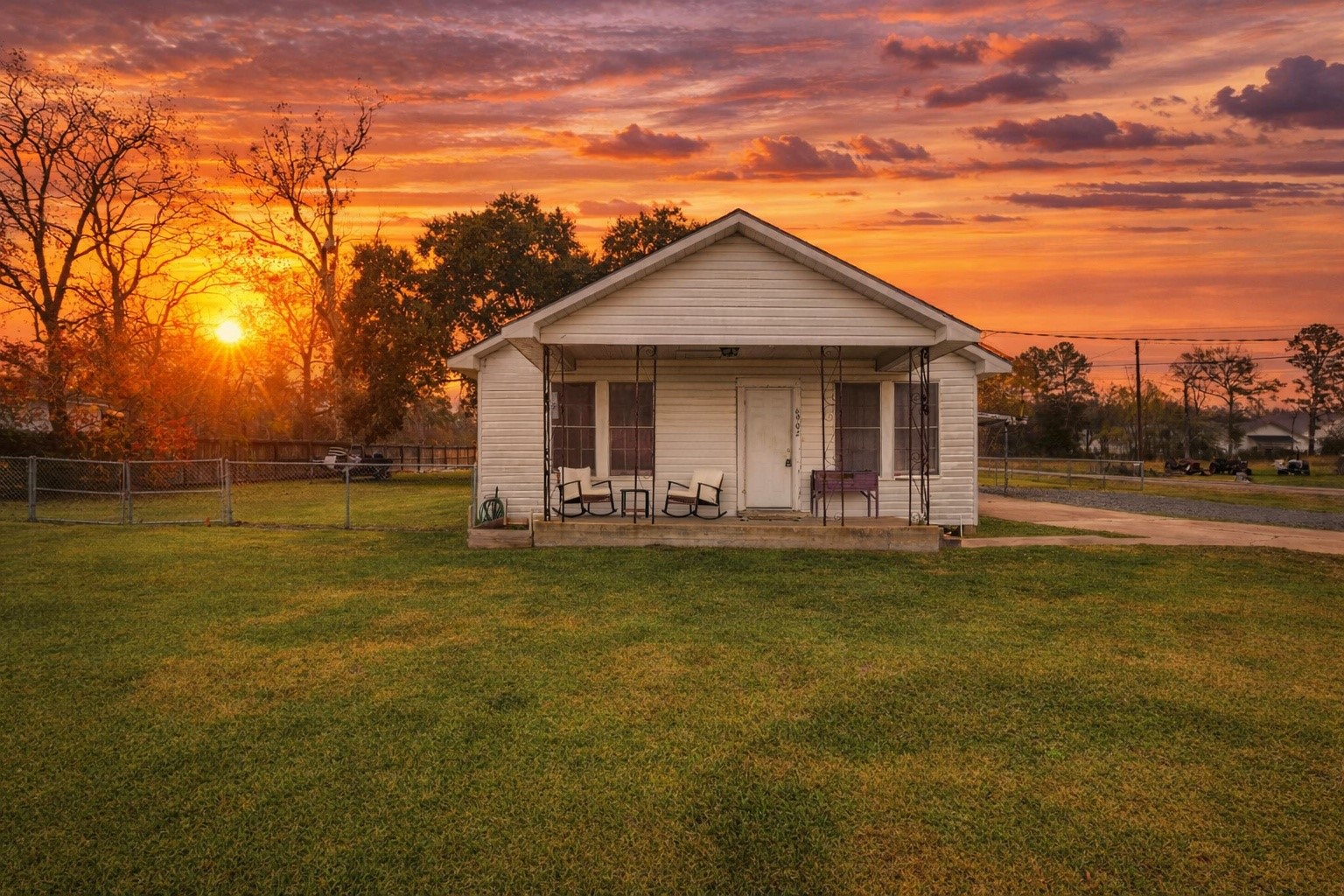 a backyard of a house with table and chairs