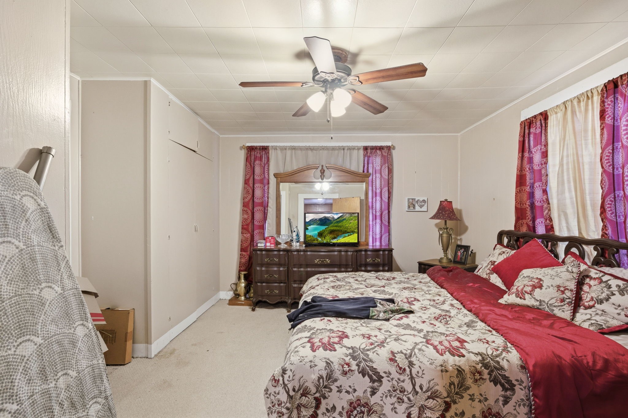 6902 Concord Road Beaumont, TX 77708 - Photo 11 of 18 a bedroom with a bed and a chandelier