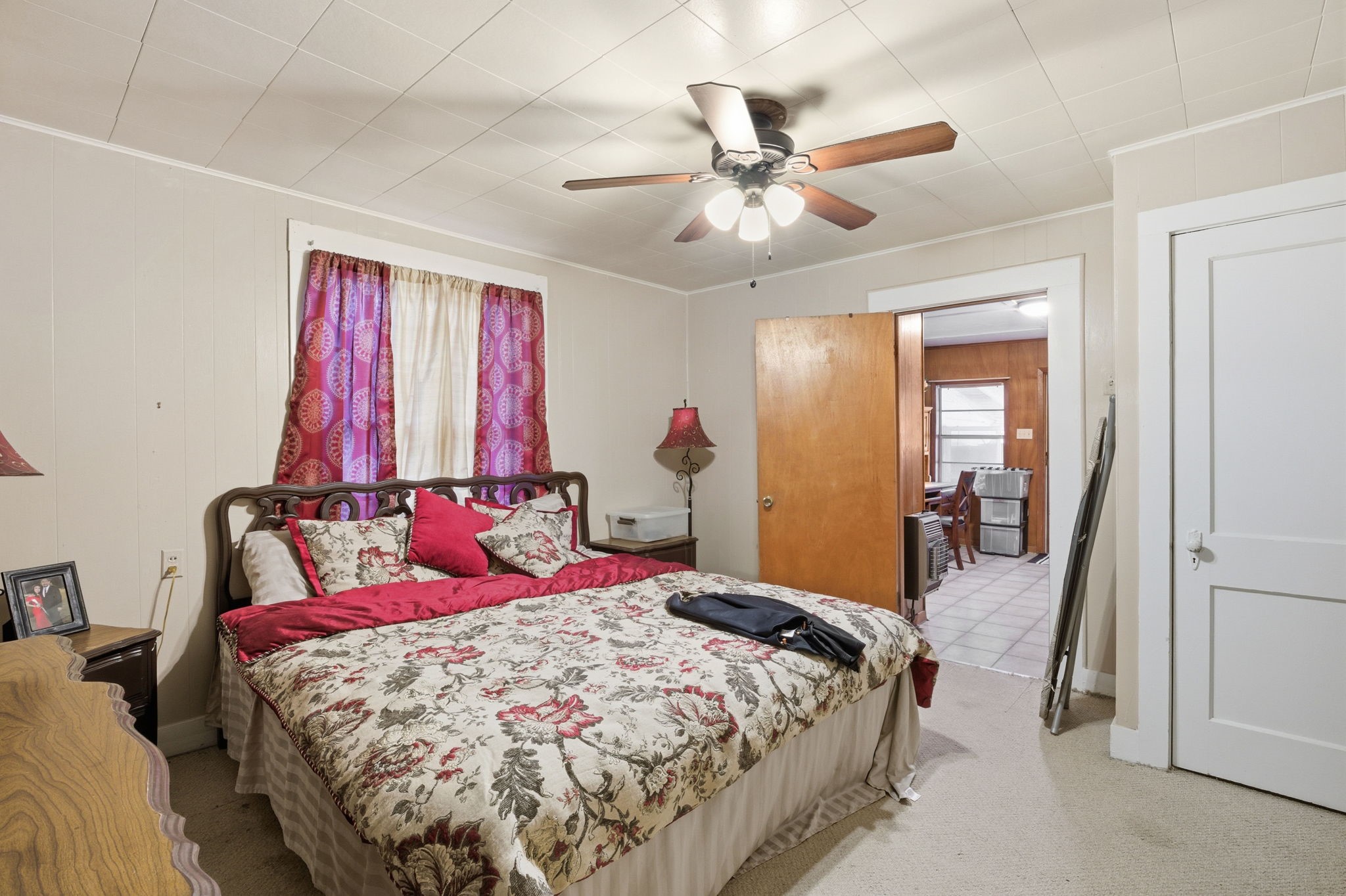 6902 Concord Road Beaumont, TX 77708 - Photo 12 of 18 a bedroom with a bed and a chandelier