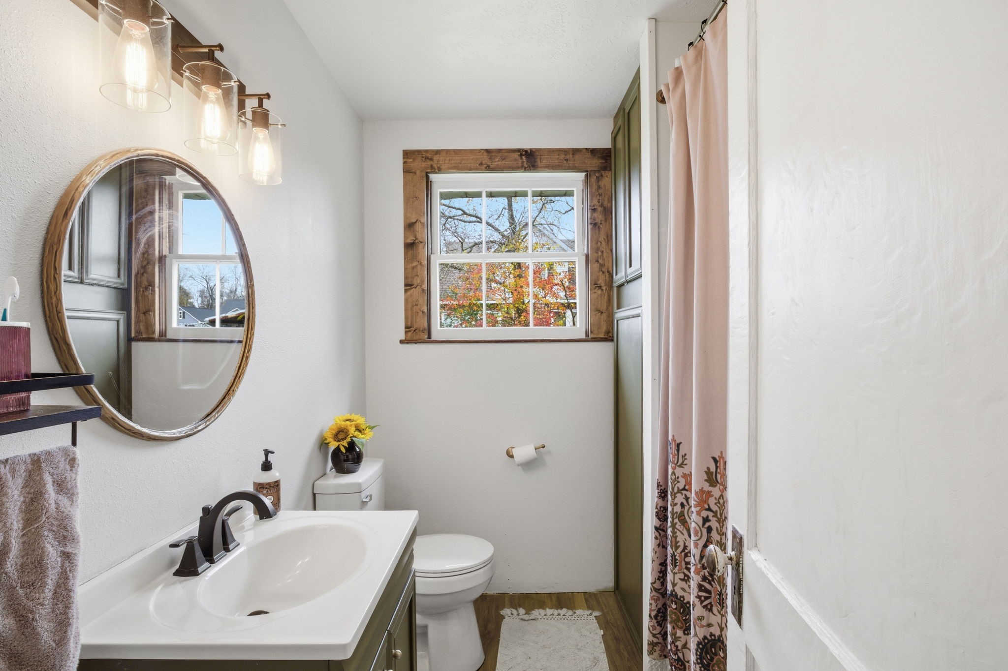 6902 Concord Road Beaumont, TX 77708 - Photo 13 of 18 a bathroom with a sink a mirror a toilet and a window
