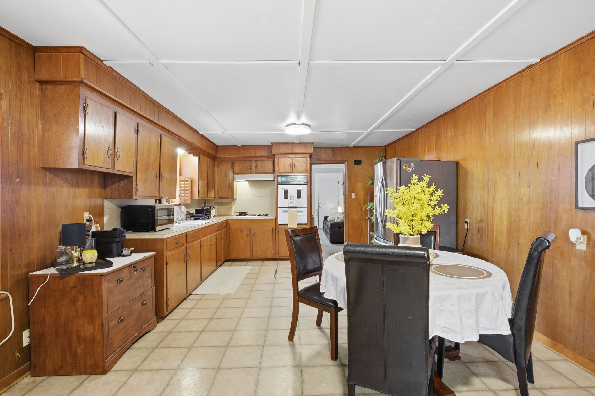 6902 Concord Road Beaumont, TX 77708 - Photo 7 of 18 a kitchen with stainless steel appliances kitchen island granite countertop a table chairs in it and a window