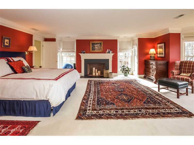 106 Goodwives River Road Darien, CT 06820 - Photo 13 of 24 a bed sitting in a bedroom next to a fireplace