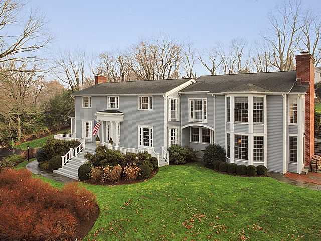 106 Goodwives River Road Darien, CT 06820 - Photo 2 of 24 a front view of a house with a garden