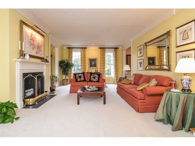 106 Goodwives River Road Darien, CT 06820 - Photo 7 of 24 a living room with furniture a large window and a fireplace
