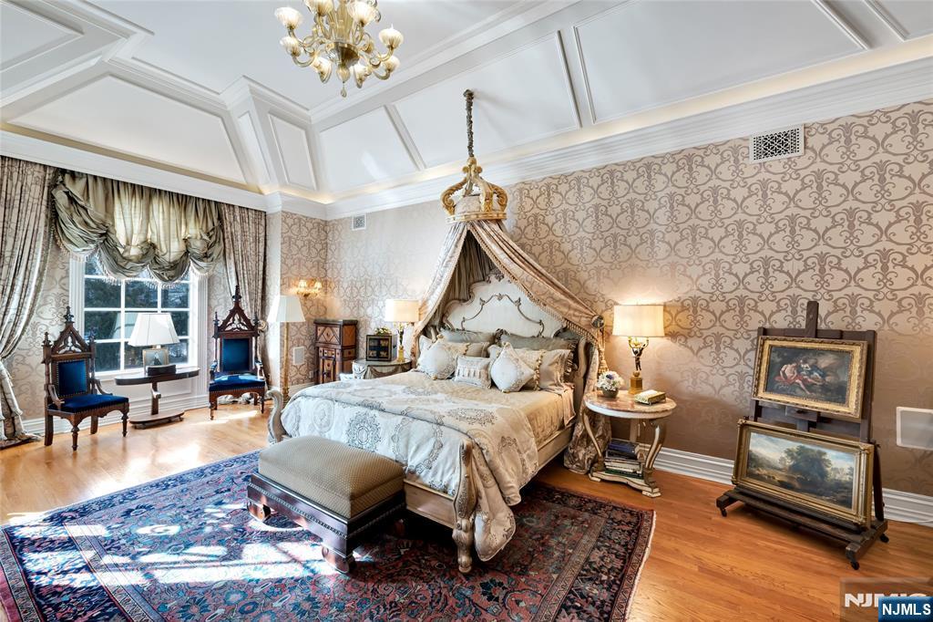 12 The Esplanade Alpine, NJ 07620 - Photo 22 of 41 a bed room with a bed furniture and a chandelier