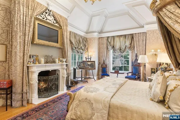 a spacious bedroom with a bed and wooden floor