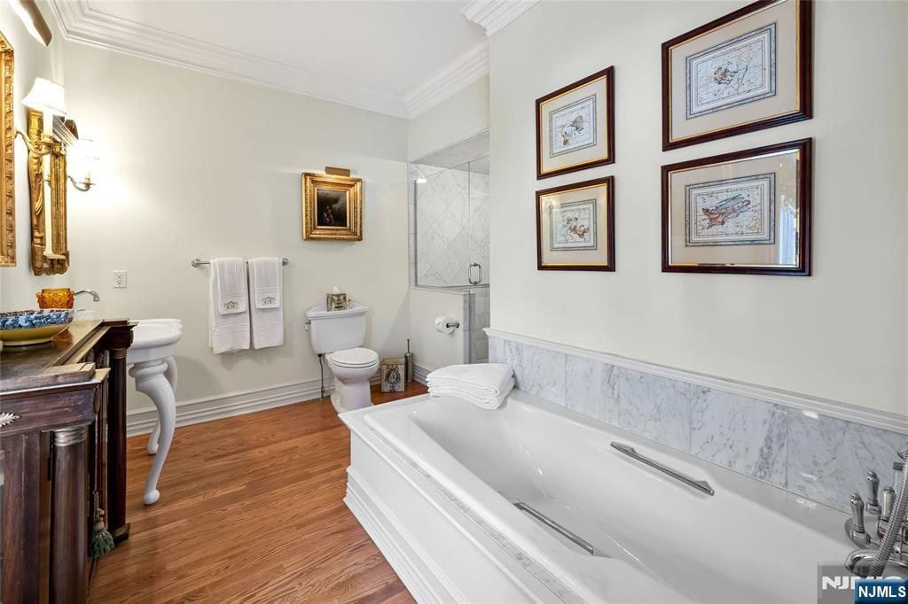 12 The Esplanade Alpine, NJ 07620 - Photo 25 of 41 a spacious bedroom with a bed and wooden floor