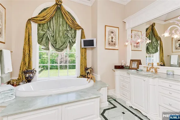 a bedroom with a bed and large windows