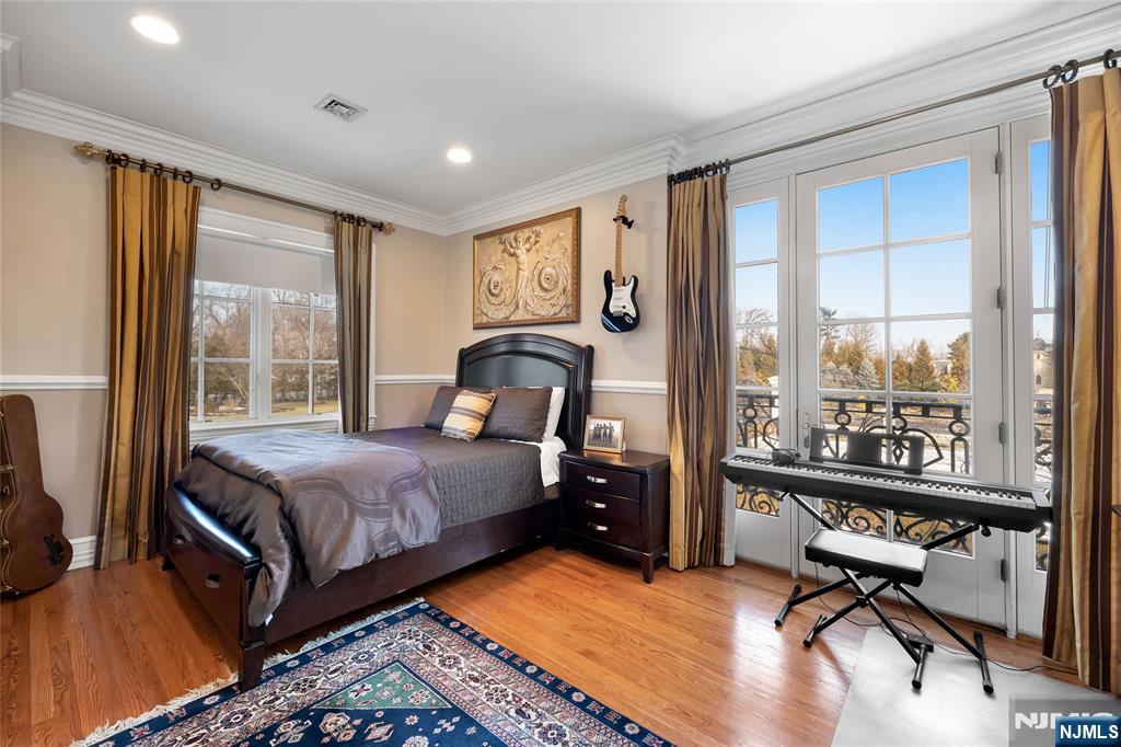 12 The Esplanade Alpine, NJ 07620 - Photo 29 of 41 a bedroom with a bed and large windows