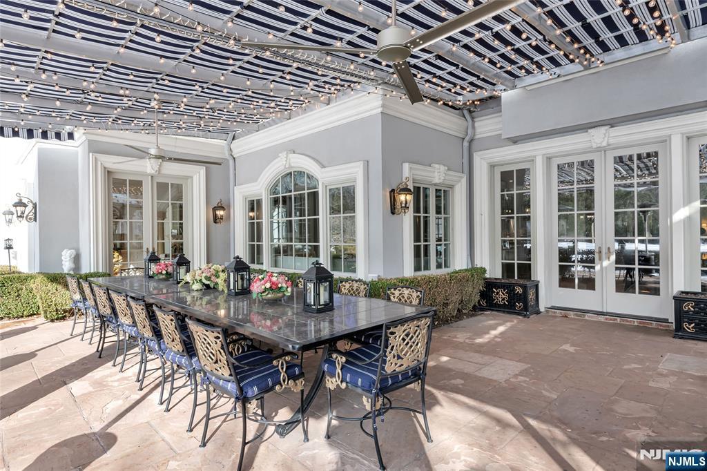 12 The Esplanade Alpine, NJ 07620 - Photo 30 of 41 a view of a dining room with furniture and floor to ceiling window