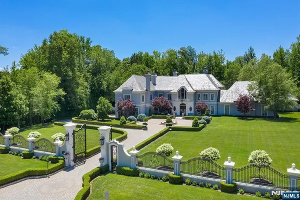 a aerial view of a house with swimming pool and yard