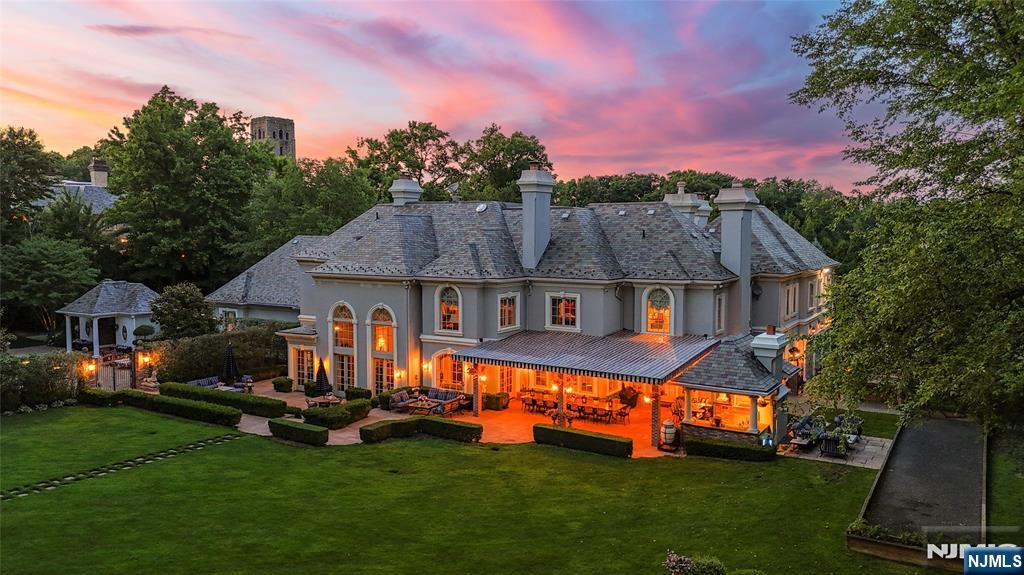 12 The Esplanade Alpine, NJ 07620 - Photo 32 of 41 a front view of a house with a garden and trees