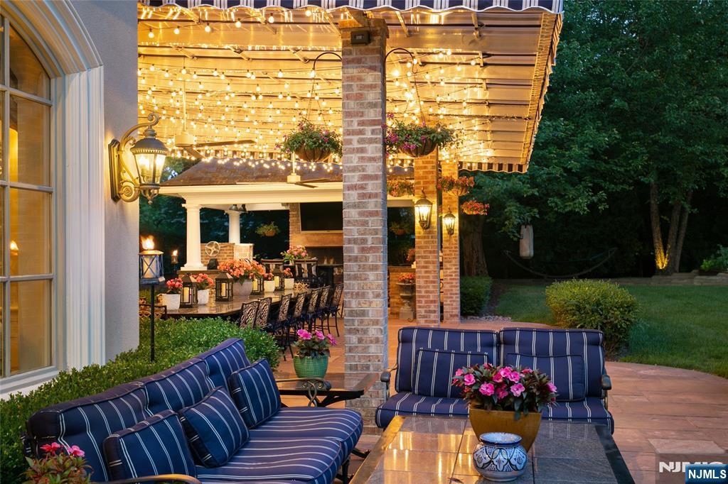 12 The Esplanade Alpine, NJ 07620 - Photo 33 of 41 a view of a patio with couches under an umbrella