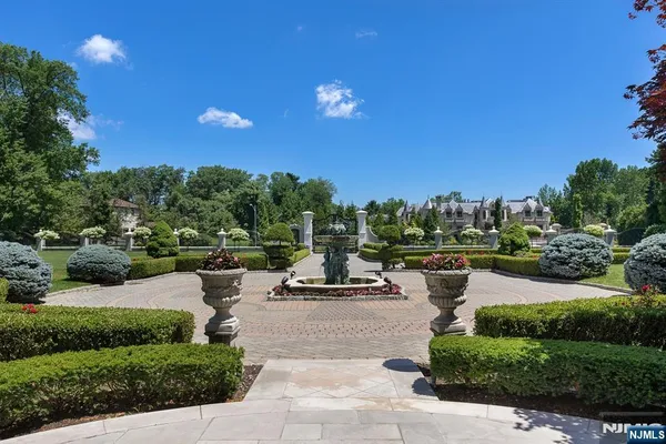a view of a garden with lawn chairs and a fire pit