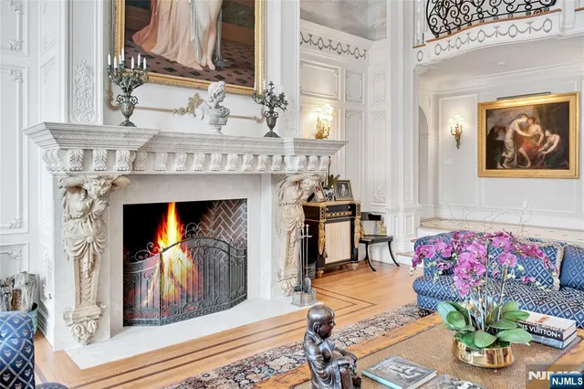 a living room with fireplace furniture and kitchen view