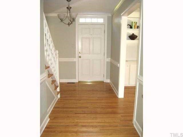 308 Sandhurst Road Raleigh, NC 27615 - Photo 2 of 12 a view of a hallway with wooden floor and staircase
