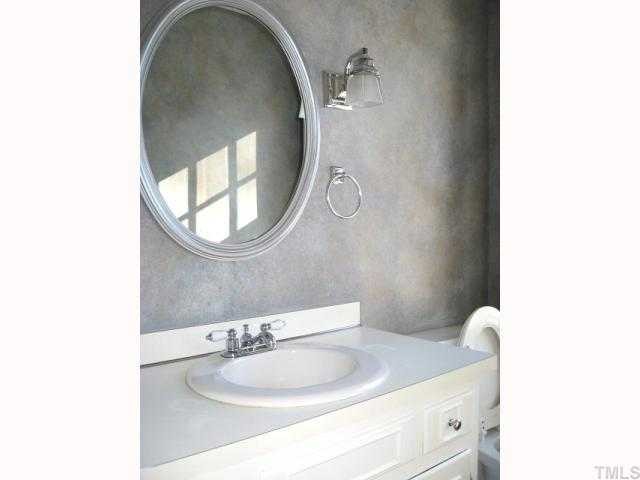 308 Sandhurst Road Raleigh, NC 27615 - Photo 7 of 12 a bathroom with a sink and a mirror