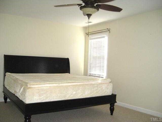 308 Sandhurst Road Raleigh, NC 27615 - Photo 8 of 12 a bed sitting in a bedroom next to a window