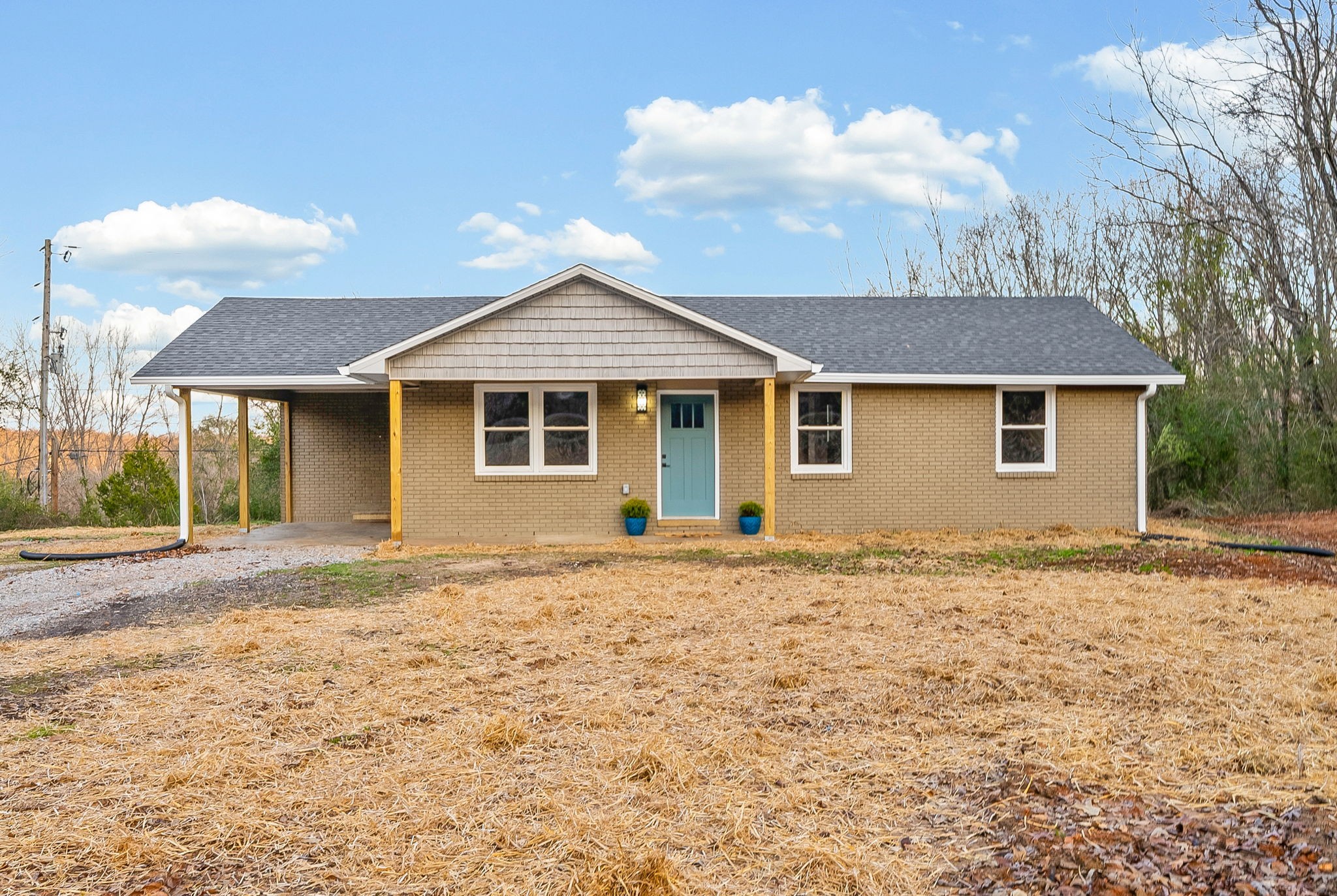 a front view of a house with a garden