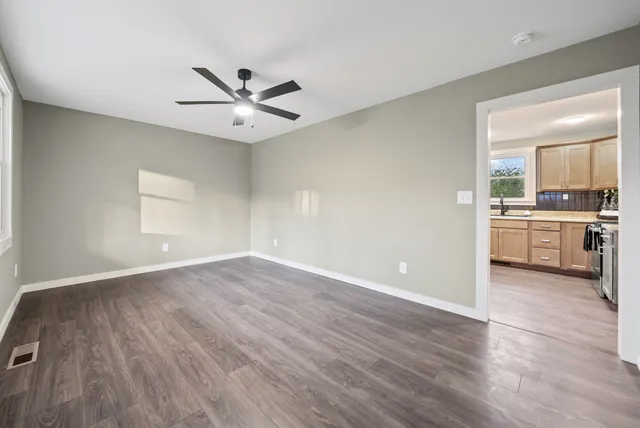 wooden floor in an empty room with a window